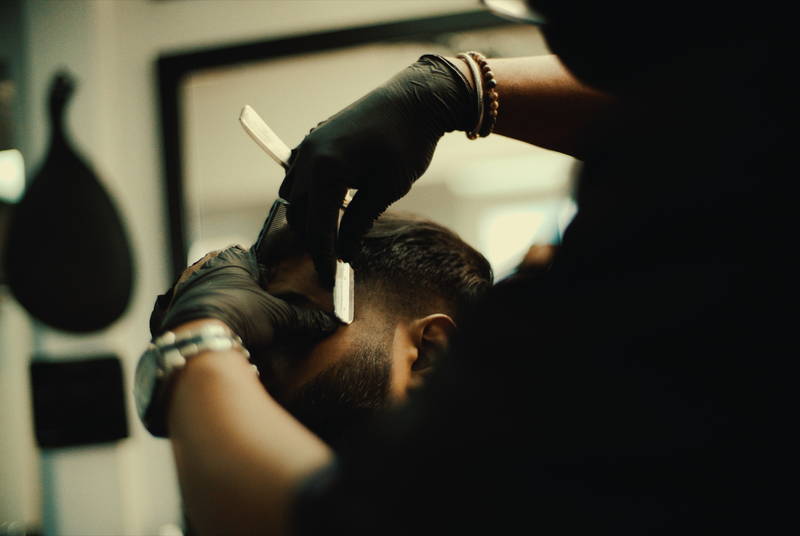 Straight razor detailing the nape at RDH Barbers, Black barbershop in Kensington Market Toronto